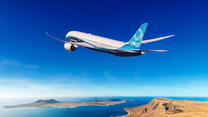 Boeing 787-9 in flight over a desert landscape